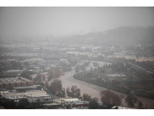 The Los Angeles river with a high water level is seen from Elysian Park on December 24, 2025 in Los Angeles, California. (Photo by Apu GOMES / AFP)

