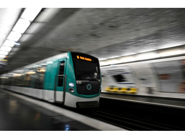 This photograph shows a subway train entering a metro station in Paris on April 1, 2024. Photo by JULIEN DE ROSA / AFP