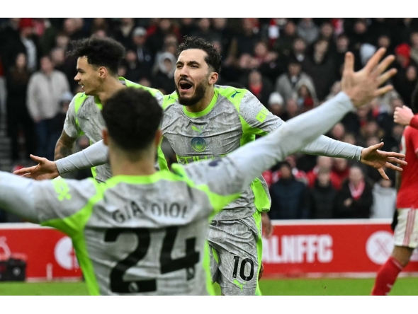 Manchester City's French midfielder 10 Rayan Cherki (C) celebrates after scoring their second goal during the English Premier League football match between Nottingham Forest and Manchester City at The City Ground in Nottingham, central England, on December 27, 2025. (Photo by Ben STANSALL / AFP) /