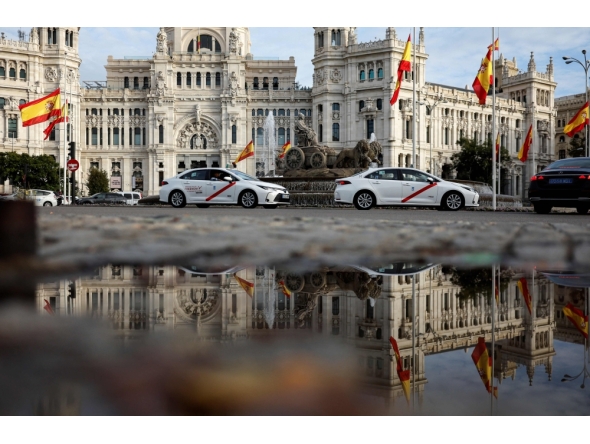 File: A picture taken on October 31, 2024 shows the Spanish flag flying at half-mast at the start of three days of national mourning after Spain's deadliest floods in decades, at Cibeles Square in Madrid. (Photo by Oscar Del Pozo / AFP)