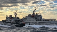 This is a handout photo taken on December 29, 2025 and released on December 30, 2025 by the Taiwan Coast Guard shows a Taiwanese coast guard ship (L) sending warnings to a Chinese coast guard ship in the waters off Taiwan's Cape Fugui. Photo by Handout / TAIWAN COAST GUARD / AFP