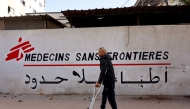 (FILES) A Palestinian man walks on his crutches to the Doctors Without Borders or Medecins Sans Frontieres (MSF) clinic, in the al-Rimal neighborhood of Gaza City on new year's Eve, December 31, 2025. (Photo by Omar AL-QATTAA / AFP)