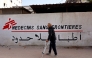 (FILES) A Palestinian man walks on his crutches to the Doctors Without Borders or Medecins Sans Frontieres (MSF) clinic, in the al-Rimal neighborhood of Gaza City on new year's Eve, December 31, 2025. (Photo by Omar AL-QATTAA / AFP)