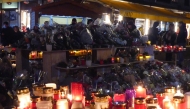 Candles and flowers are displayed at a makeshift memorial following a fire at 
