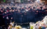 Firefighters from the Municipality of Crans-Montana react as they gather around a makeshift memorial to pay their respects by laying flowers, candles and messages near the Constellation, on January 4, 2026, in Crans-Montana in honour of the victims of the fire that ripped through the venue in the luxury Alpine ski resort on New Year's Eve. Photo by MAXIME SCHMID / AFP
