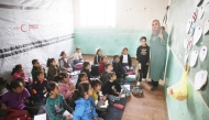 Palestinian children, many of whom are part of displaced families, sit on the floor as they attend class, at the UNRWA Deir Al-Balah Joint School, west of Deir Al-Balah. (AFP)