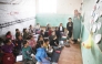 Palestinian children, many of whom are part of displaced families, sit on the floor as they attend class, at the UNRWA Deir Al-Balah Joint School, west of Deir Al-Balah. (AFP)