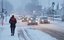 Traffic moves slowly through heavy snowfall in Aalborg, northern Denmark on January 7, 2026. (Photo by Henning Bagger / Ritzau Scanpix / AFP) / Denmark OUT
