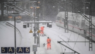 Workers clear the snow from the platforms at Hamburg main railway station in Hamburg, Germany, on January 9, 2026 (Photo by DANIEL REINHARDT / AFP)