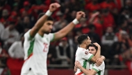 Morocco's forward #10 Brahim Diaz (R) celebrates scoring his team's first goal with Morocco's defender #02 Achraf Hakimi (2nd R) during the Africa Cup of Nations (CAN) quarter-final football match between Cameroon and Morocco at the Prince Moulay Abdallah stadium in Rabat on January 9, 2026. (Photo by Gabriel Bouys / AFP)