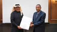 Director General of the Qatar Press Center Sadiq Mohammed Al-Amari (left) honouring former Sudanese Minister of Foreign Affairs, and Professor of Islamic Studies at Hamad Bin Khalifa University Dr. Mustafa Osman Ismail. 