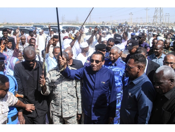 Sudan's Prime Minister Kamil Idris (front, C) waves as he arrives to deliver an address in Khartoum on January 11, 2026. Idris announced on January 11, 2026, the government's return to Khartoum, after nearly three years of operating from its wartime capital of Port Sudan. (Photo by Ebrahim HAMID / AFP)