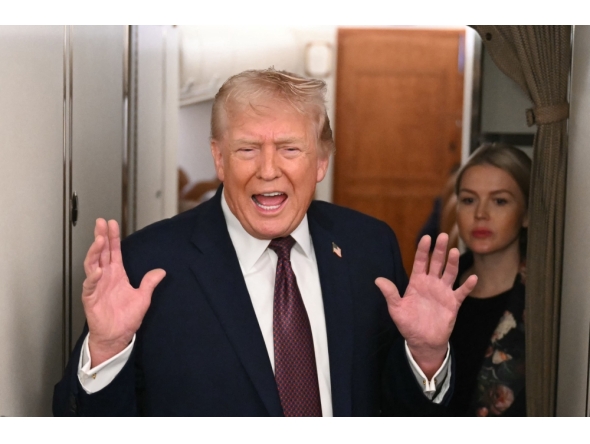 US President Donald Trump speaks to the press aboard Air Force One on January 11, 2026. (Photo by Andrew Caballero-Reynolds / AFP)