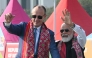 German Chancellor Friedrich Merz and Indian PM Narendra Modi wave to the crowd in Ahmedabad on January 12, 2026. (Photo by Shammi MEHRA / AFP)