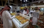 Visitors look at prayer beads at the Katara International Exhibition for Kahraman, showcasing artwork and handicrafs made with amber, at the Katara cultural village in Doha on January 13, 2026. (Photo by Karim JAAFAR)