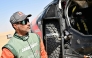Nasser Al Attiyah stands next to his car after competing in Stage 9. PIC: AFP 