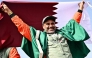 The Dacia Sandriders' Qatari driver Nasser al-Attiyah holds Qatar's flag while celebrating his win in the 48th edition of the Dakar Rally 2026 in Yanbu, Saudi Arabia. (Photo by Giuseppe Cacace / AFP)
 