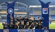 New Zealand's players celebrate with the trophy after winning the series and the third ODI cricket match between India and New Zealand at the Holkar cricket Stadium in Indore on January 18, 2026. (Photo by Indranil MUKHERJEE / AFP)