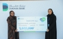 A Dukhan Bank official presenting the grand prize to the winner.
