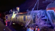 This video grab taken from videos posted on social media and verified by AFPTV teams in Madrid, shows emergency personnel working after a train accident in Adamuz, southern Spain, on January 18, 2026. (Photo by -UGC / @eleanorinthesky (via X) / AFP) 