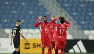 Karl Toko Ekambi (left) and Salem Reda celebrate a goal against Al Sadd yesterday. 