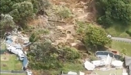 This screen grab made from UGC footage shows the site of a landslide in Mount Maunganui. A landslide smashed into a campsite in rain-swept northern New Zealand on January 22, leaving multiple people missing under tonnes of mud. (Photo by Handout / Amy Till, Solsea Swim / AFP) 