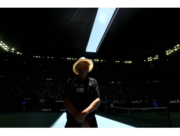 A security officer looks on as the roof of Rod Laver Arena is closed due to extreme heat during the men's singles match between Italy's Jannik Sinner and USA's Eliot Spizzirri in Melbourne on January 24, 2026. (Photo by David Gray / AFP) 