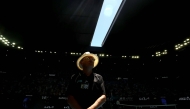 A security officer looks on as the roof of Rod Laver Arena is closed due to extreme heat during the men's singles match between Italy's Jannik Sinner and USA's Eliot Spizzirri in Melbourne on January 24, 2026. (Photo by David Gray / AFP) 