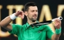 Serbia’s Novak Djokovic mimics playing a violin on his racket as he celebrates victory over Netherlands’ Botic van de Zandschulp on January 24, 2026. (Photo by Martin Keep / AFP)
