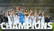 Akram Afif lifts the Super Shield as Al Sadd's players and officials celebrate their triumph.
