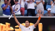 USA's Learner Tien celebrates victory over Russia's Daniil Medvedev after their men's singles match on day eight of the Australian Open tennis tournament in Melbourne on January 25, 2026. (Photo by David Gray / AFP)