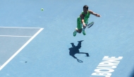 Spain's Carlos Alcaraz hits a return against USA's Tommy Paul during their men's singles match on day eight of the Australian Open tennis tournament in Melbourne on January 25, 2026. (Photo by Izhar Khan / AFP)