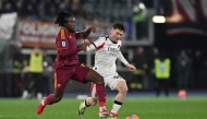 Roma's French midfielder #17 Manu Kone (L) and AC Milan's Belgian midfielder #56 Alexis Saelemaekers (R) fight for the ball during the Italian Serie A football match between AS Roma and AC Milan at the Olympic Stadium in Rome on January 25, 2026. (Photo by Andreas SOLARO / AFP)