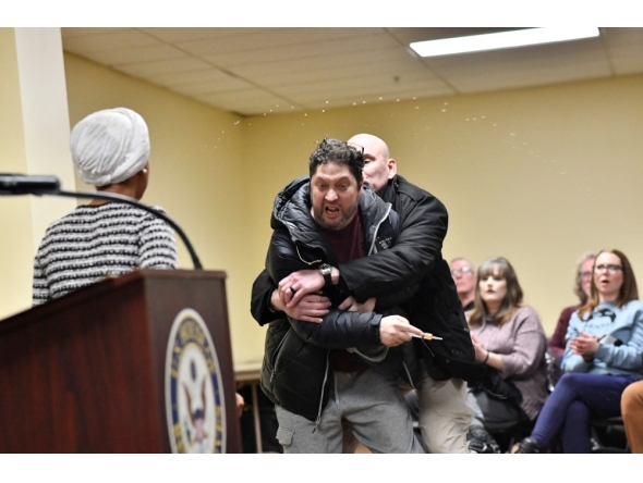 A man is tackled after spraying an unknown substance at US Representative Ilhan Omar (D-MN) (L) during a town hall she was hosting in Minneapolis, Minnesota, on January 27, 2026. (Photo by Octavio Jones / AFP)