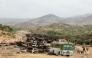 Villagers return from a market to Yechila town in south central Tigray walking past scores of burned vehicles, in Tigray, Ethiopia, on July 10, 2021. File Photo / Reuters