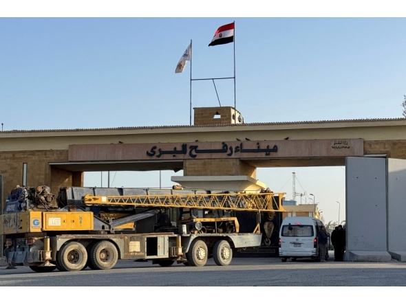 A construction crane enters through the Egyptian side of the Rafah border crossing with the Gaza Strip in northeastern Egypt on February 1, 2026. (Photo by AFP)
 
