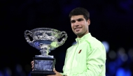 Spain's Carlos Alcaraz poses with the Norman Brookes Challenge Cup after defeating Serbia's Novak Djokovic in Melbourne on February 1, 2026. (Photo by Martin Keep / AFP)