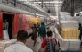 Passengers walk past a cargo compartment on a long-distance train platform at the Chhatrapati Shivaji Maharaj Terminus (CSMT) in Mumbai on February 1, 2026. (Photo by Punit PARANJPE / AFP)