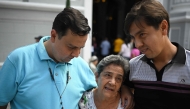 Human rights activist Javier Tarazona (L) greets his brother Jose Rafael Tarazona (R) and his mother Teresa de Jesus Sanchez after his release from prison at La Candelaria church in Caracas on February 1, 2026. (Photo by Federico PARRA / AFP)