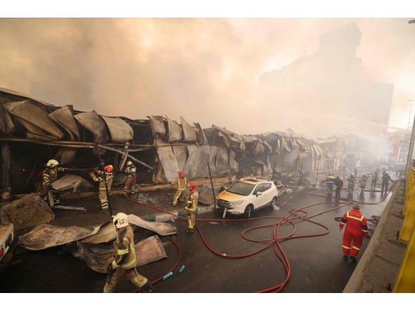 Smoke rises as firefighters battle a fire that broke out in Jannat Bazaar, west of Tehran on February 3, 2026. Photo by Atta Kenare / AFP 