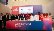 Founder and Chief Executive Officer of Snoonu Hamad Mubarak Al Hajri with representatives of Alvarez & Marsal and other attendees during a signing ceremony on the sidelines of Web Summit.