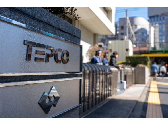 The logo of Tokyo Electric Power Company is seen at an entrance to the company's headquarters in Tokyo on February 9, 2026. (Photo by Kazuhiro NOGI / AFP)