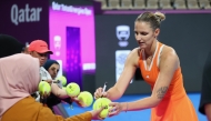 Karolina Pliskova of the Czech Republic signs autographs after the match against Amanda Anisimova of the United States.