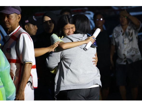 This handout photo released by the Songkhla Provincial Public Relations Office on February 11, 2026 shows a child reacting outside a school following a shooting near Hat Yai in southern Thailand's Songkhla province. (Photo by Handout / Songkhla Provincial Public Relations Office / AFP) 