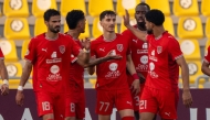 Al Duhail’s Adel Boulbina (centre) celebrates with teammates. 