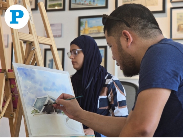 Adrian Aleluya live-painting during the exhibition. Pic by Hana Ramadan/The Peninsula