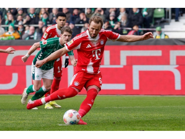 Bayern Munich's English forward #09 Harry Kane scores the opening goal from the penalty spot during the German first division Bundesliga football match between SV Werder Bremen and FC Bayern Munich in Bremen, northern Germany, February 14, 2026. (Photo by Focke Strangmann / AFP)