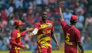 West Indies' Jason Holder (C) celebrates with teammates after taking the wicket of Nepal's Dipendra Singh Airee during the 2026 ICC Men's T20 Cricket World Cup group stage match between Nepal and West Indies at the Wankhede Stadium in Mumbai on February 15, 2026. (Photo by Indranil Mukherjee / AFP)