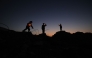 Young displaced Palestinians play on the ruins of destroyed buildings, carrying Ramadan lanterns, in central Gaza Strip on February 15, 2026. (Photo by Eyad Baba / AFP)
 