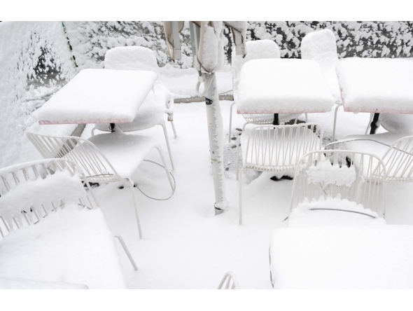 Snow covers chairs and tables of a cafe as winter strikes Vienna, Austria with snow and freezing temperatures on February 20, 2026. (Photo by Joe Klamar / AFP)